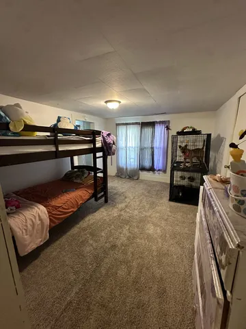 a bedroom with a bed and a mirror