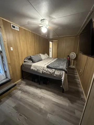 a bedroom with a bed and a television