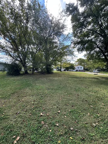 a living room with furniture a flat screen tv and gym equipment