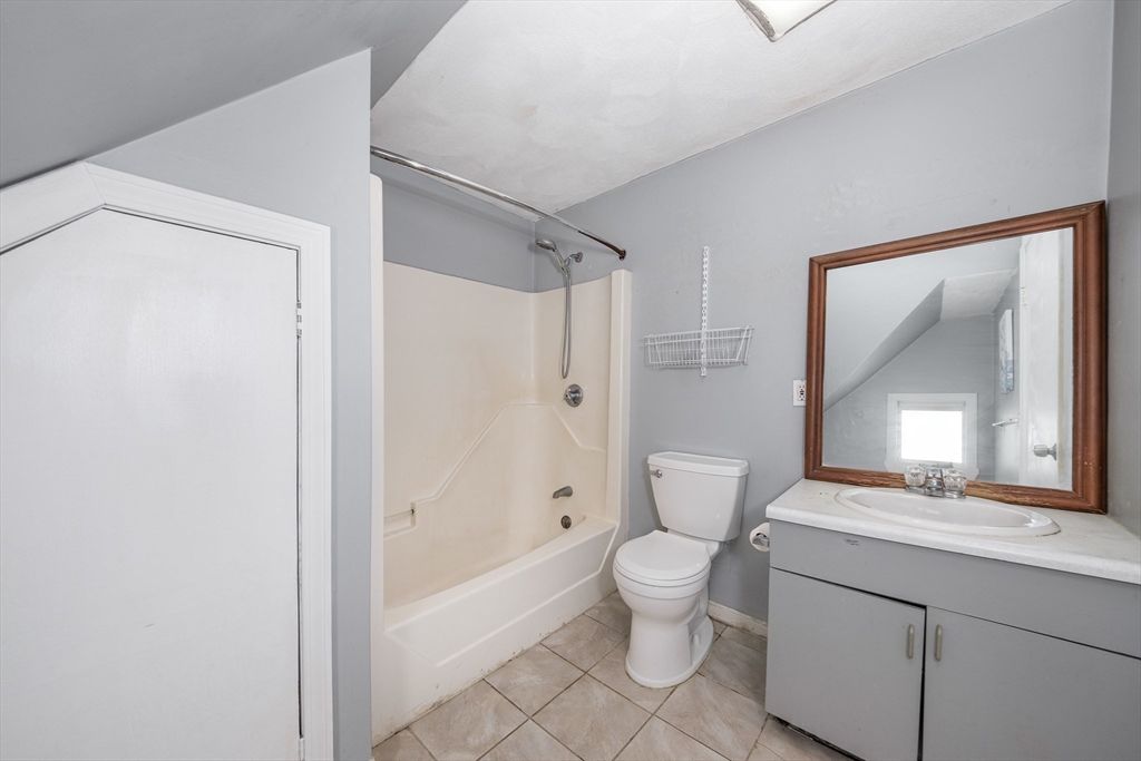 20 Hatch Street Everett, MA 02149 - Photo 3 of 16 a bathroom with a toilet sink and a mirror