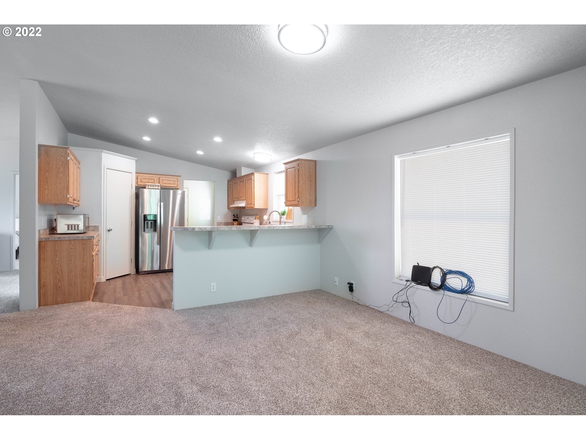 1499 Callahan Road Roseburg, OR 97471 - Photo 18 of 32 a view of an empty room with kitchen and a window