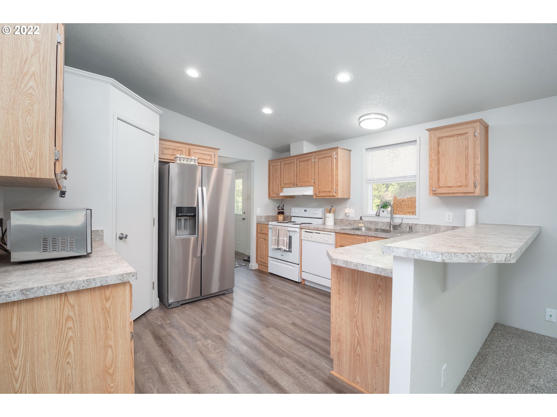 1499 Callahan Road Roseburg, OR 97471 - Photo 19 of 32 a kitchen with a refrigerator sink and cabinets