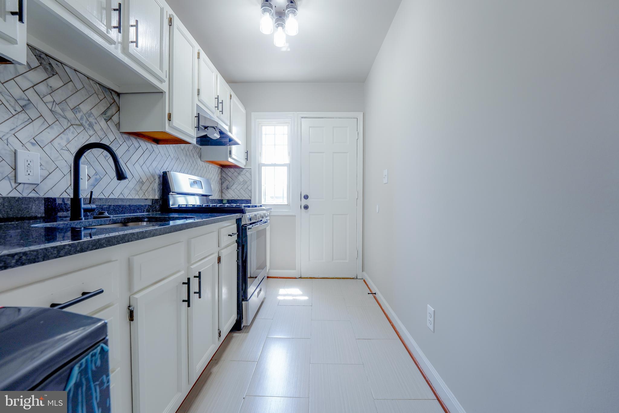 1823 H Place Northeast, Unit 3 Washington, DC 20002 - Photo 6 of 16 a bathroom with double vanity and two mirrors