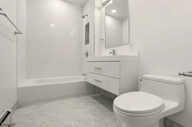 a bathroom with a toilet a sink and bathtub