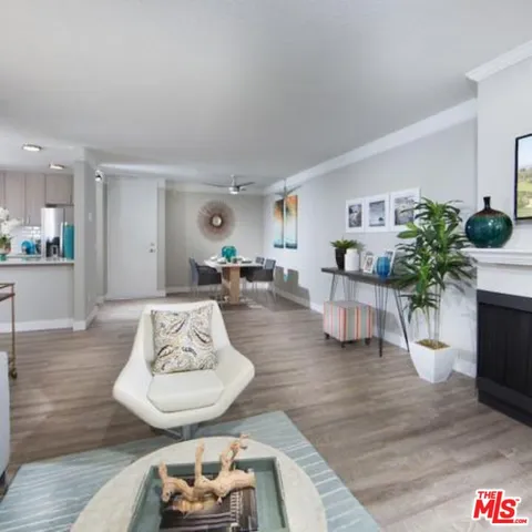 a living room with furniture potted plant and a table