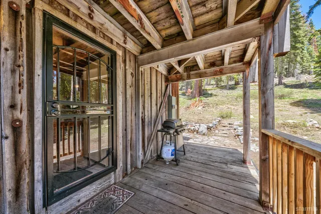 a view of a porch with wooden floor and furniture