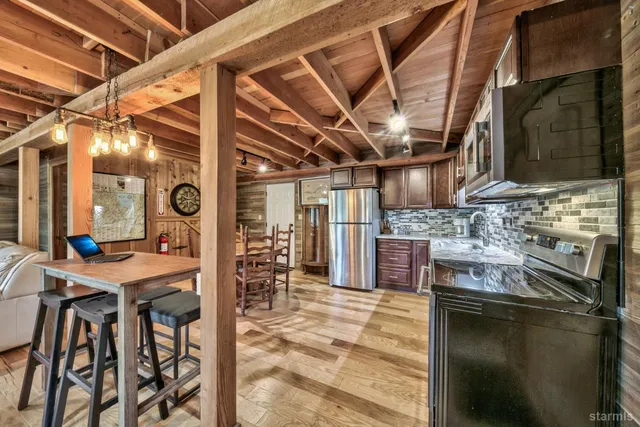 a kitchen with stainless steel appliances granite countertop a sink and cabinets
