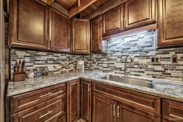 a kitchen with stainless steel appliances granite countertop a sink and cabinets