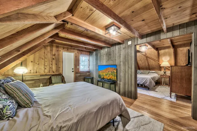 a bedroom with a bed and a mirror