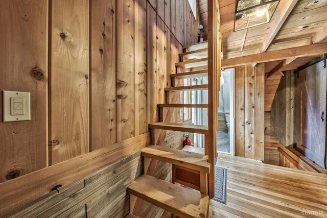 a reading room with wooden floor and furniture