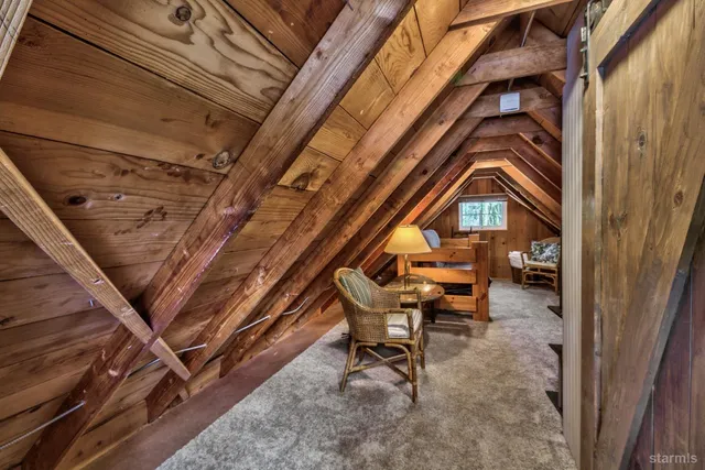 a backyard view with a couple of chairs