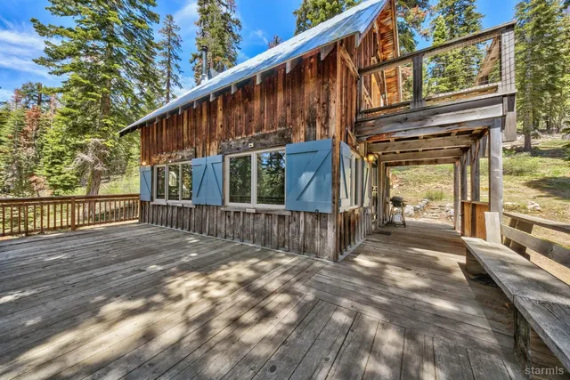 a view of a house with wooden fence