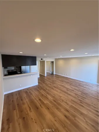 a view of kitchen and a sink with wooden floor