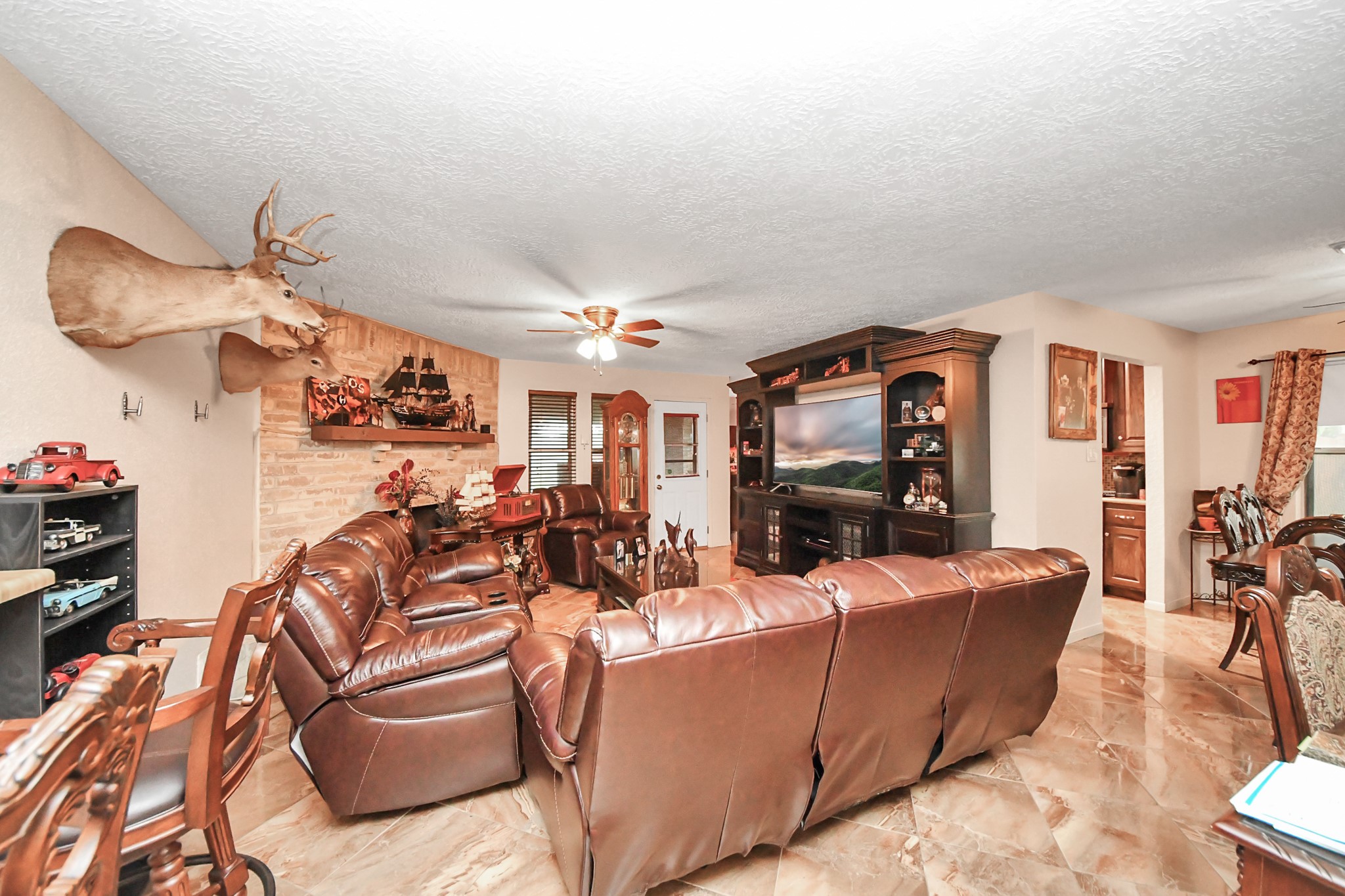 37 Wagon Ln Loop Angleton, TX 77515 - Photo 14 of 42 a living room with furniture a flat screen tv and a floor to ceiling window