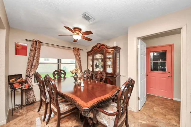 a view of a dining room with furniture and chandelier