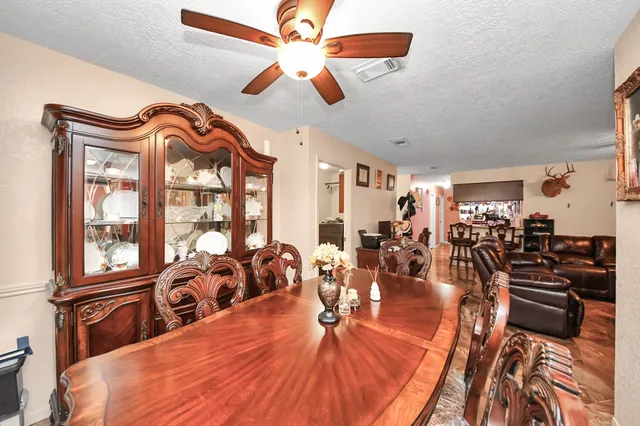 a very nice looking living room with a large window with kitchen view