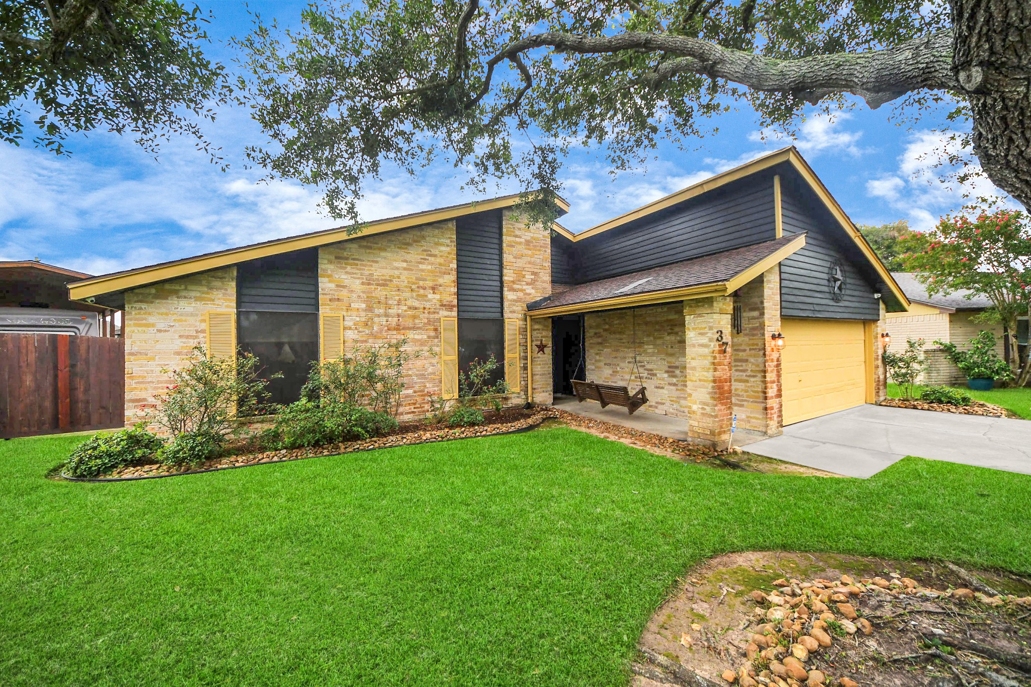 37 Wagon Ln Loop Angleton, TX 77515 - Photo 2 of 42 a front view of a house with a yard and garage