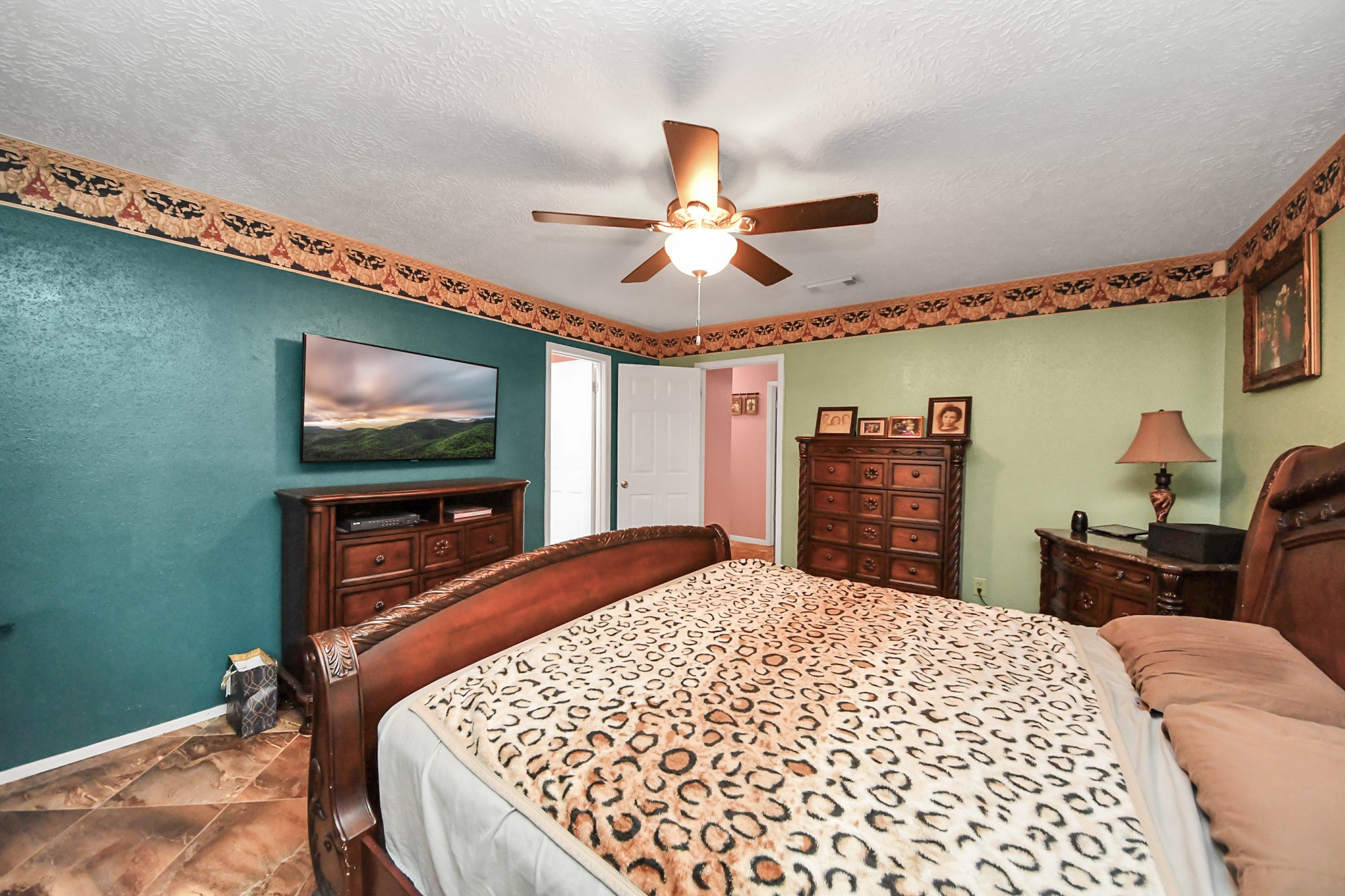 37 Wagon Ln Loop Angleton, TX 77515 - Photo 24 of 42 a bedroom with a bed and a flat screen tv