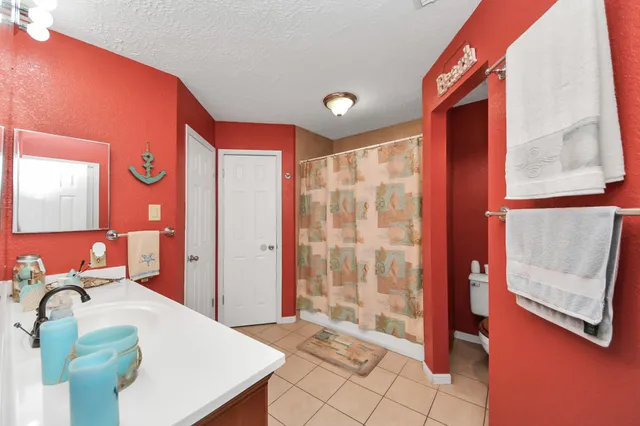 a bedroom with a bed and a mirror