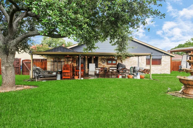 a view of a house with a yard and sitting area