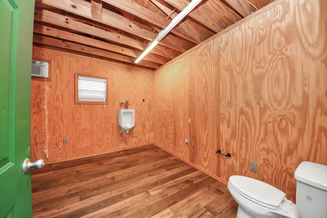 a bathroom with a toilet and a shower curtain