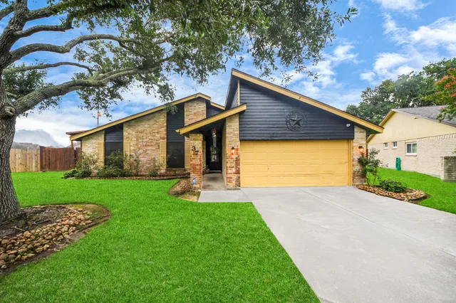a front view of a house with a yard and porch