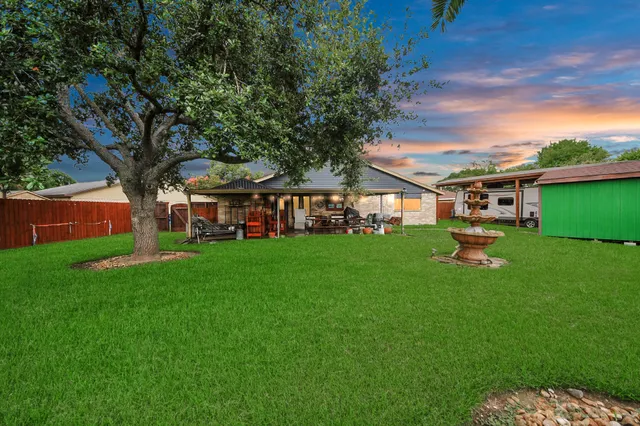 a view of a house with a backyard porch and sitting area