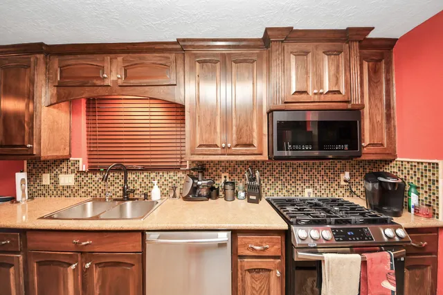 a kitchen with granite countertop a sink and a stove