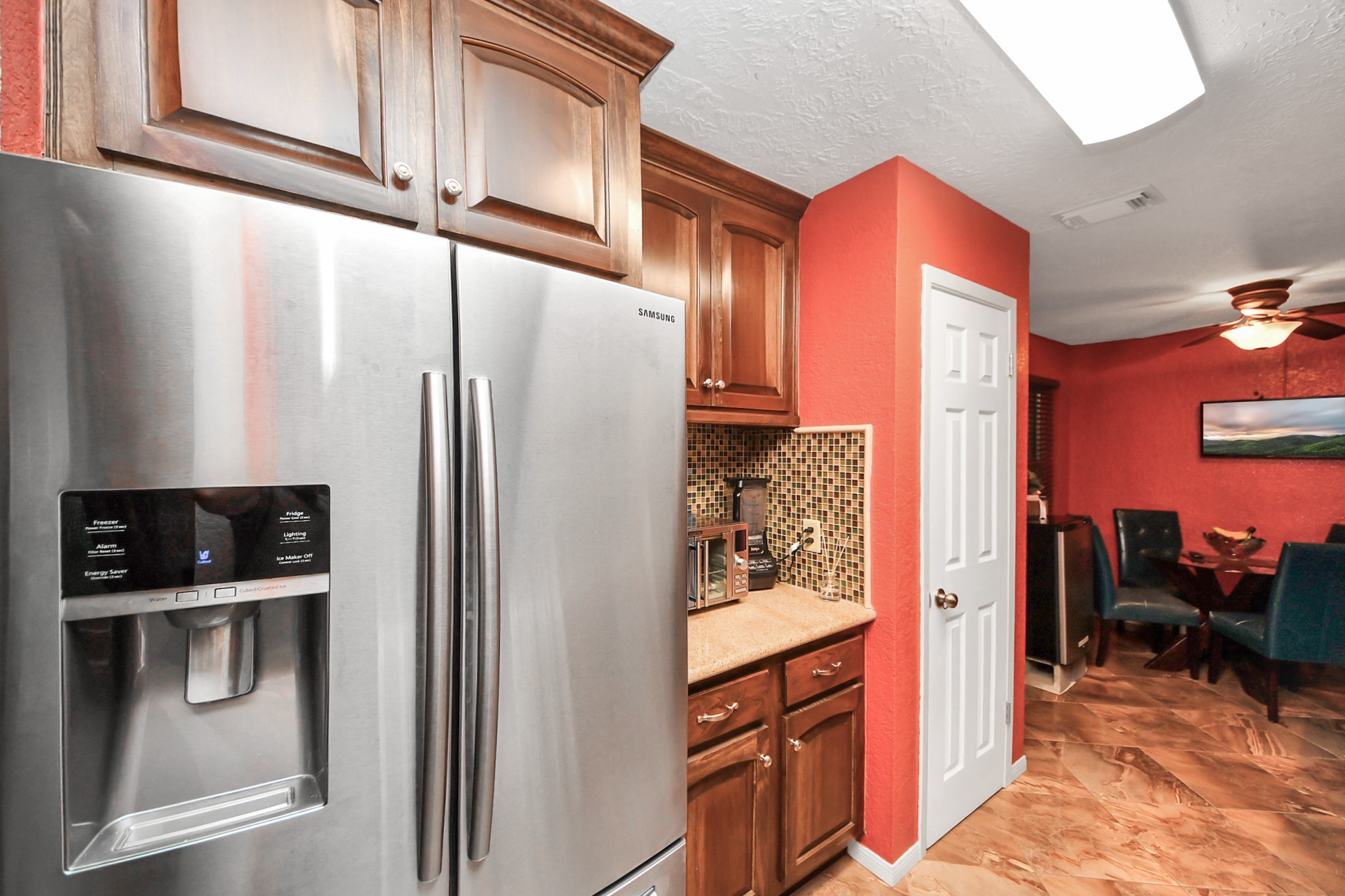 37 Wagon Ln Loop Angleton, TX 77515 - Photo 10 of 42 a kitchen with stainless steel appliances a refrigerator a stove and cabinets