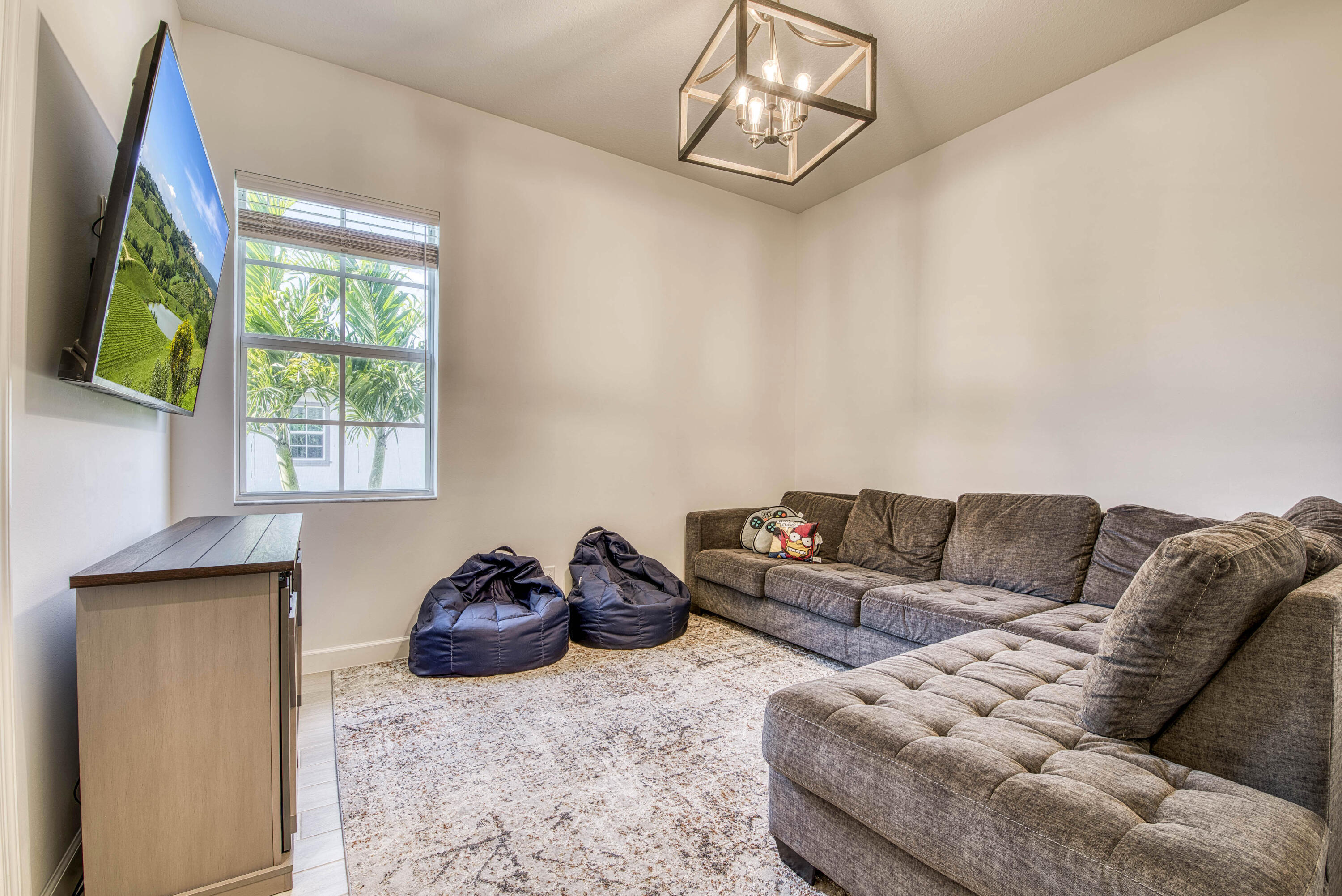 19017 Fly Rod Run Loxahatchee, FL 33470 - Photo 40 of 106 a living room with furniture a flat screen tv and a window