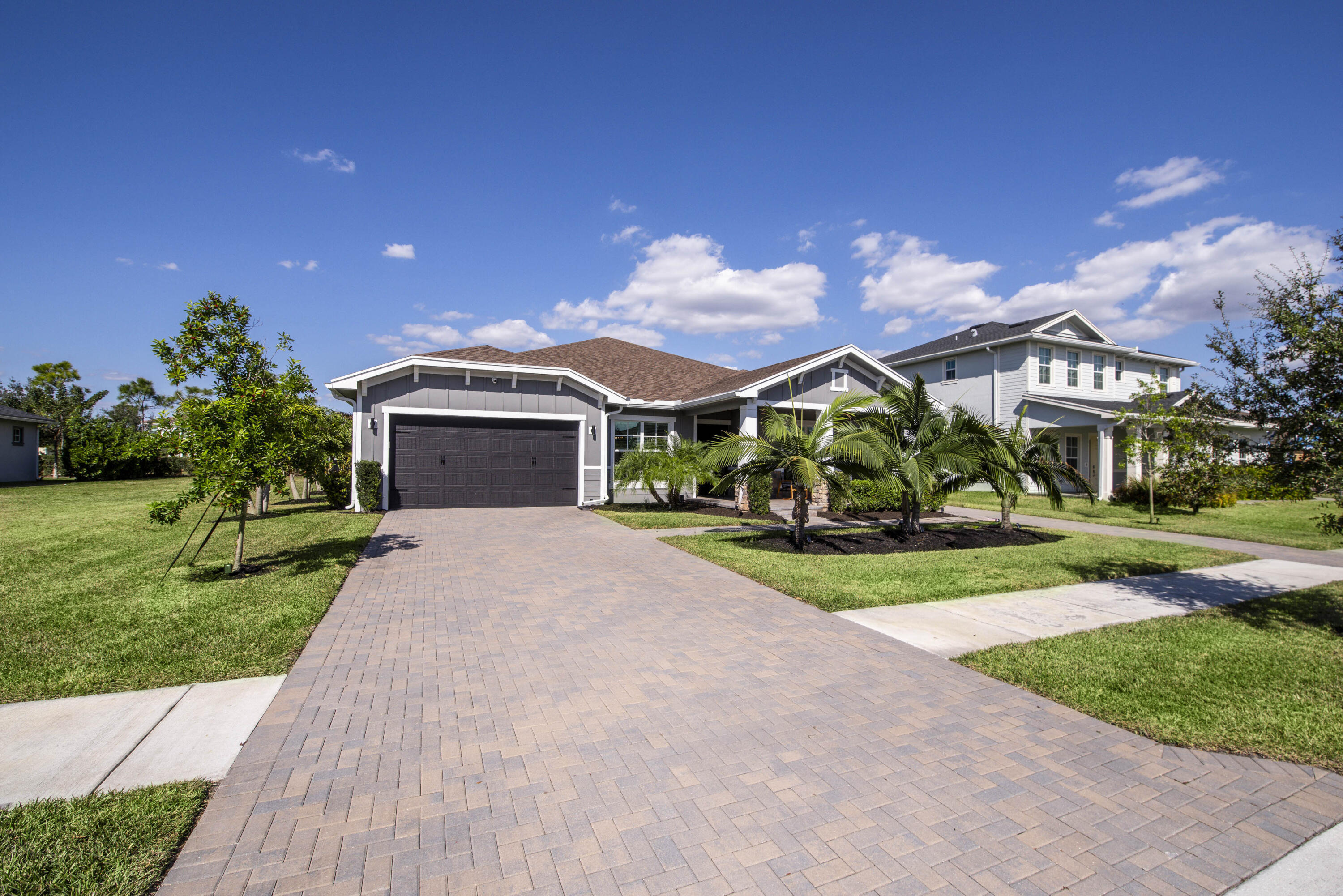 19017 Fly Rod Run Loxahatchee, FL 33470 - Photo 53 of 106 a front view of a house with a yard and garage