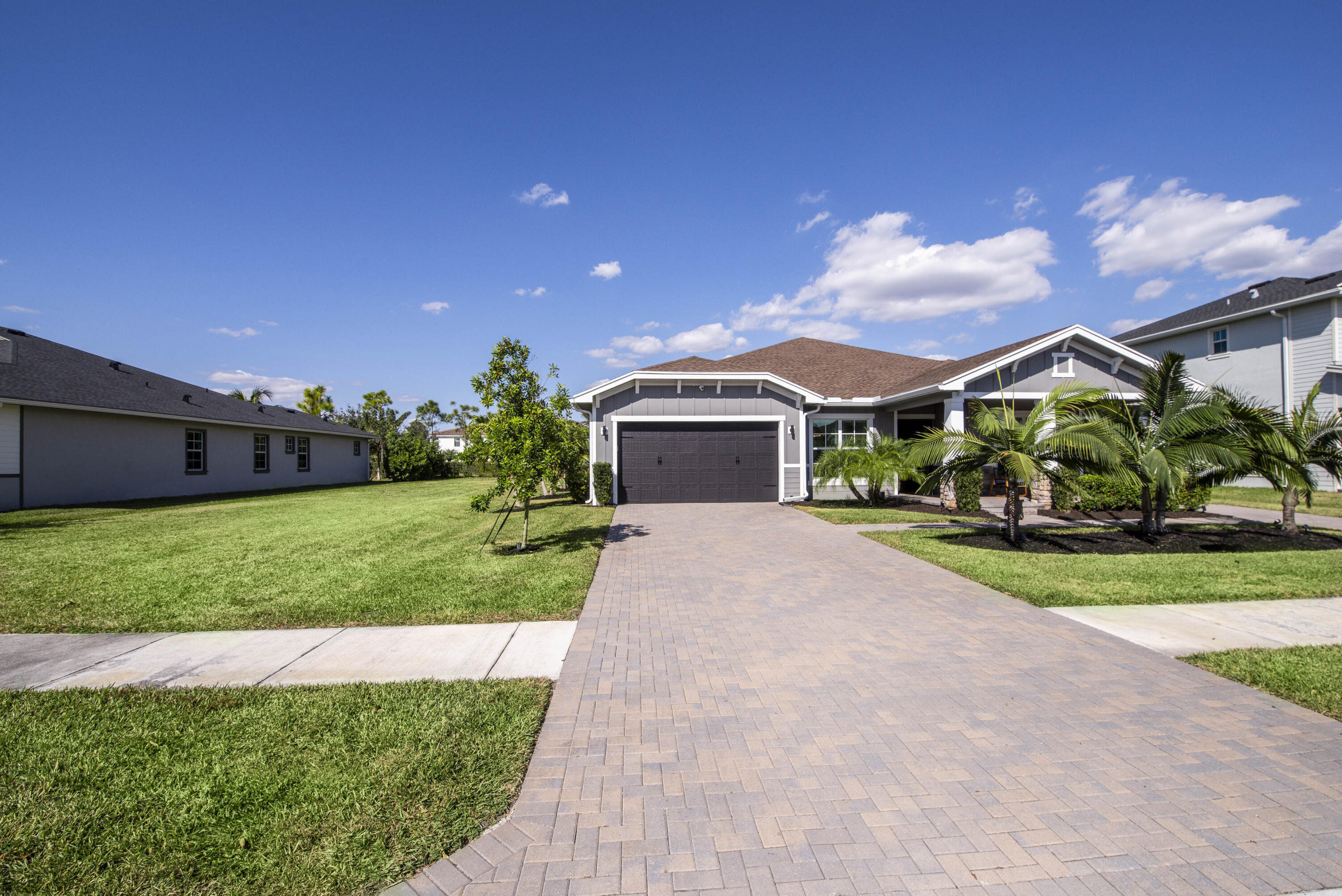 19017 Fly Rod Run Loxahatchee, FL 33470 - Photo 54 of 106 a front view of a house with a yard and garage