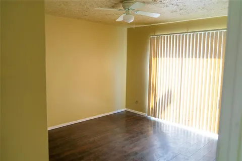 a view of a livingroom with wooden floor and a window