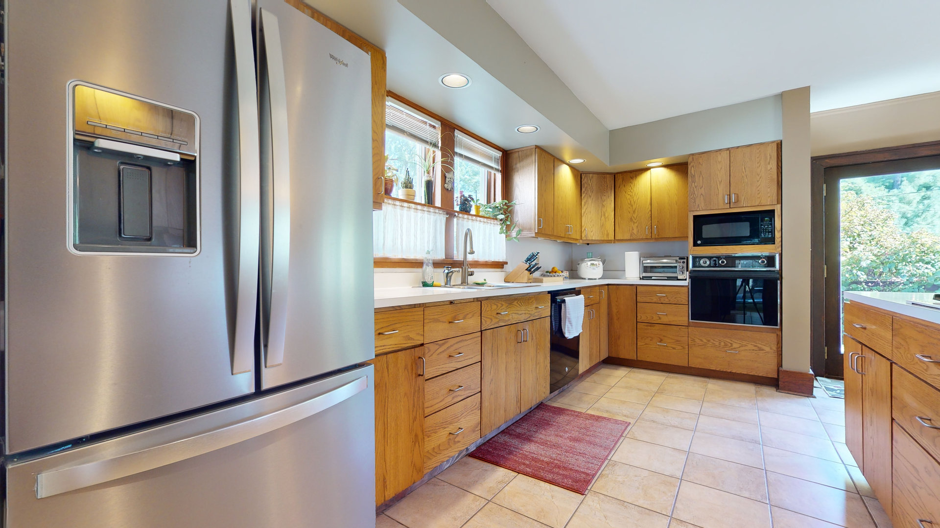 916 West Daniel Street Champaign, IL 61821 - Photo 14 of 46 a kitchen with stainless steel appliances granite countertop a refrigerator and a stove top oven