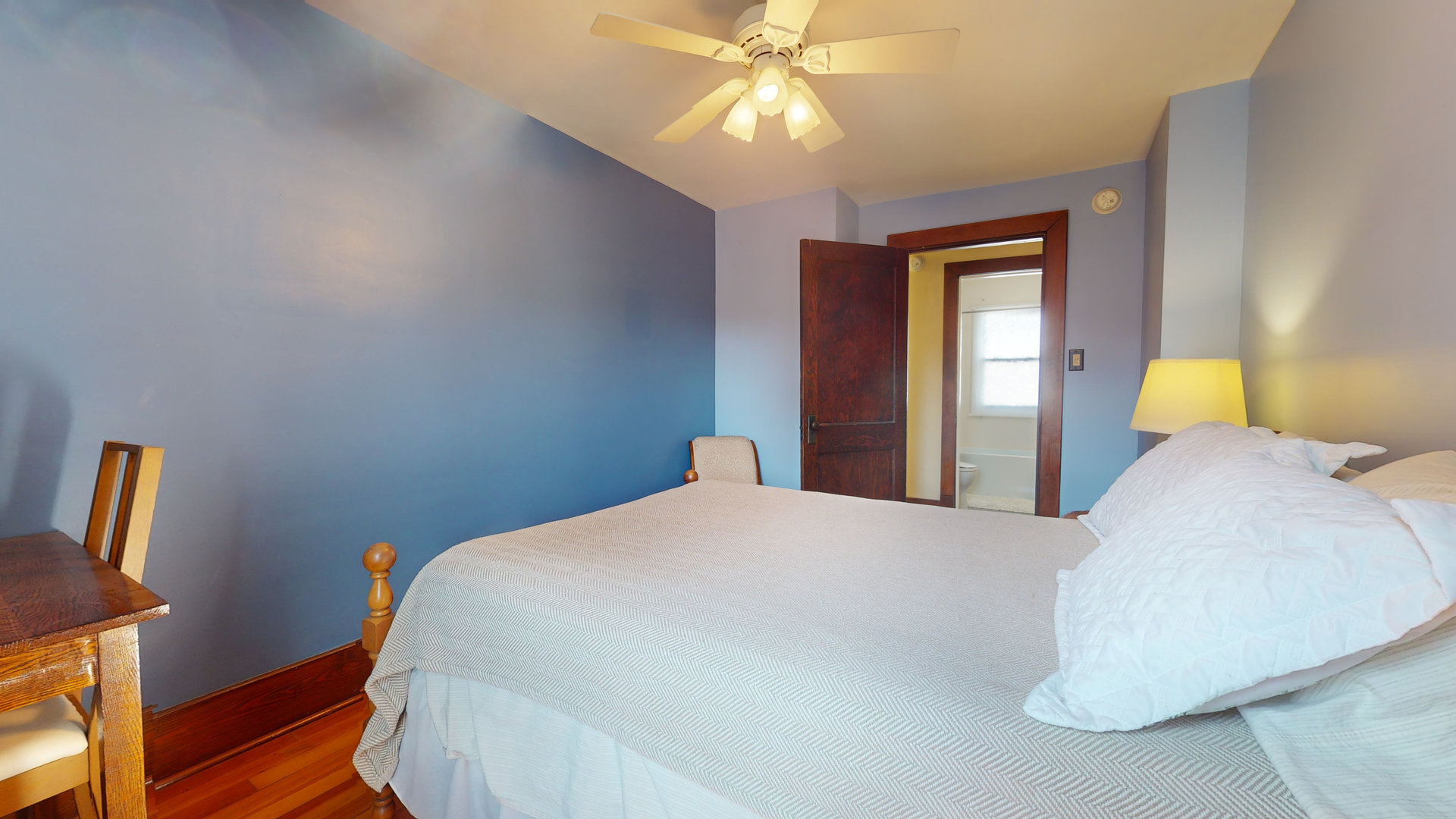 916 West Daniel Street Champaign, IL 61821 - Photo 27 of 46 a bedroom with a bed and a chandelier