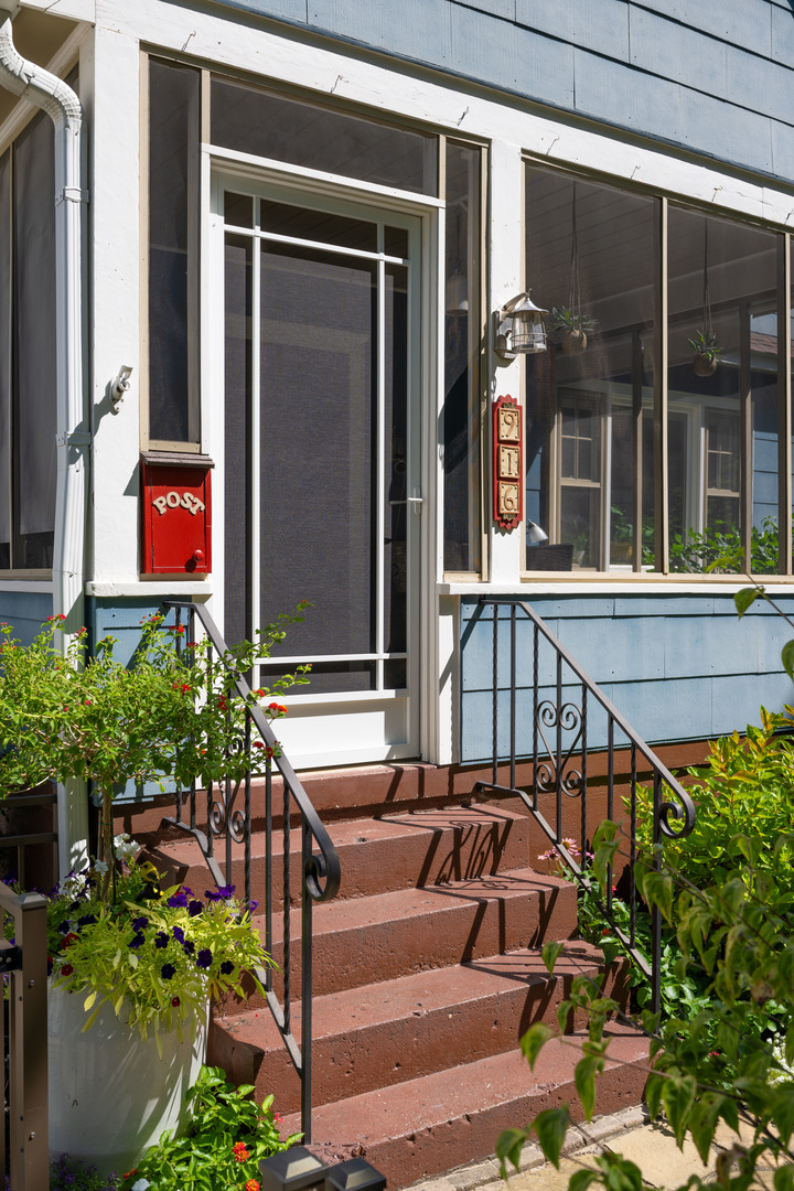 916 West Daniel Street Champaign, IL 61821 - Photo 3 of 46 a view of a house with potted plants and a bench