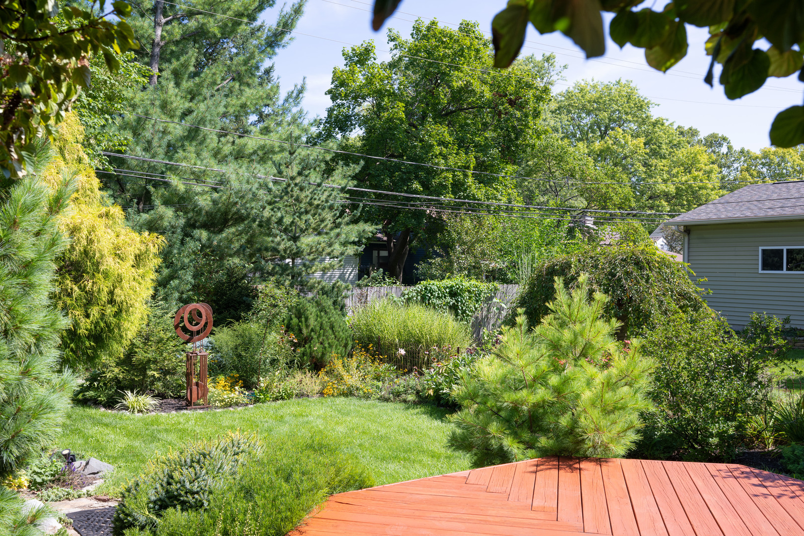 916 West Daniel Street Champaign, IL 61821 - Photo 39 of 46 a view of a backyard with potted plants and large trees