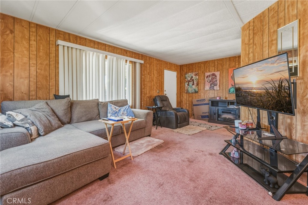 20683 Waalew Road, Unit B201 Apple Valley, CA 92307 - Photo 10 of 32 a living room with furniture a flat screen tv and a window