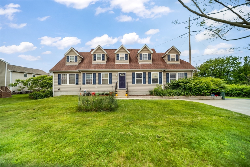 a view of a house with a yard table and chairs