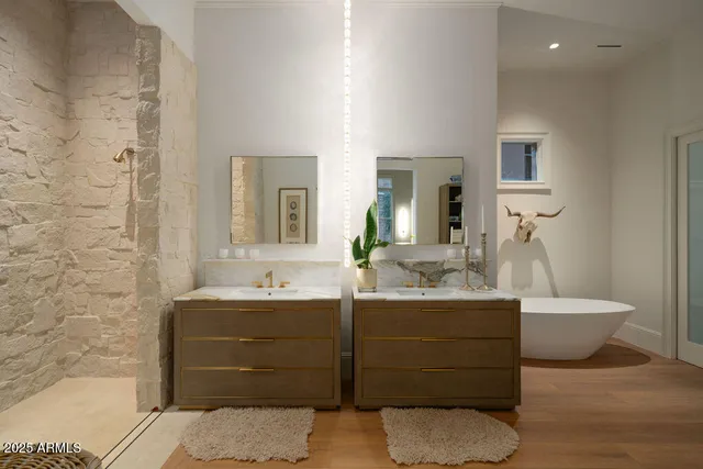 a bathroom with a bathtub sink and mirror