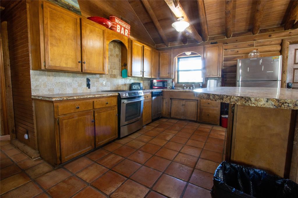Tbd Vicars Road Bowie, TX 76230 - Photo 21 of 40 a large kitchen with a sink and cabinets