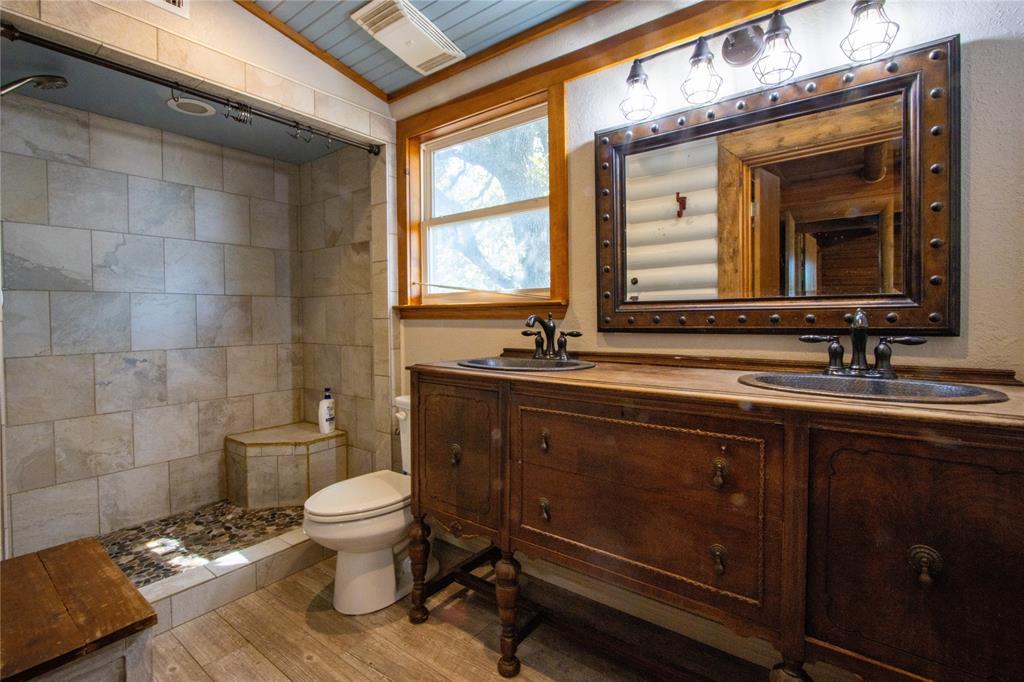 Tbd Vicars Road Bowie, TX 76230 - Photo 25 of 40 a bathroom with a sink a toilet a mirror and a window