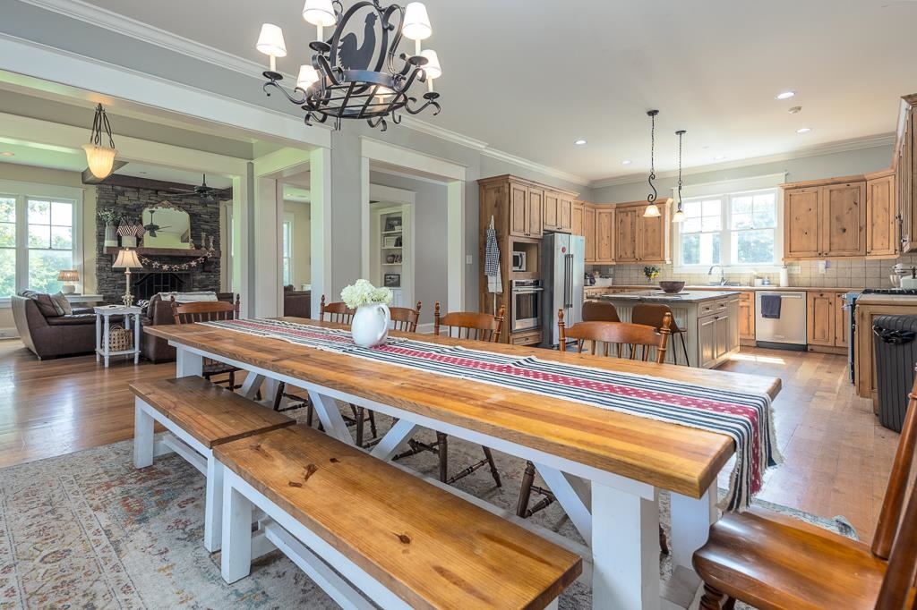 1915 Teague Store Road Somerville, TN 38068 - Photo 21 of 38 Spacious dining area with a long wood-finish table and benches, featuring an overhead decorative chandelier