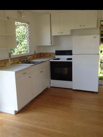 765 Haiku Road Haiku, HI 96708 - Photo 17 of 25 a kitchen with granite countertop a stove a sink and a refrigerator