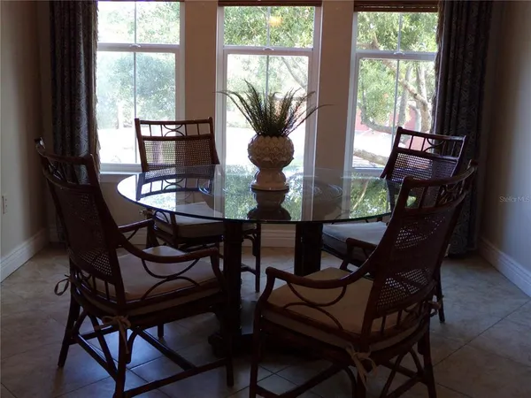 a view of a dining room with furniture and window