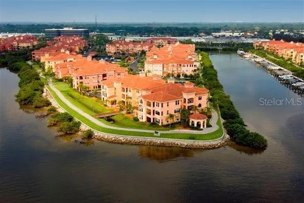 an aerial view of a house with a garden and lake view