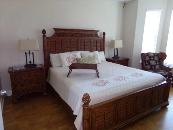 a bed sitting in a bedroom next to a lamp