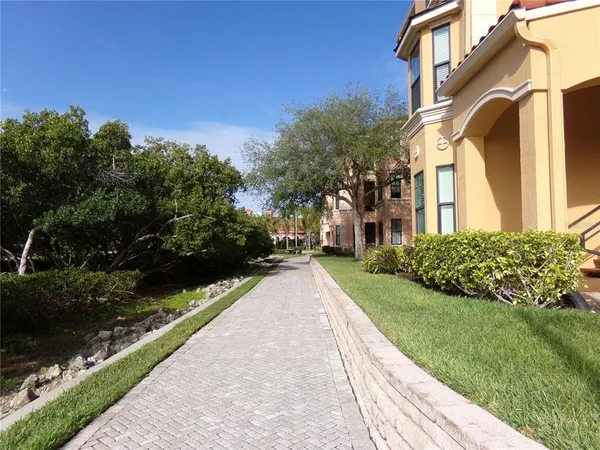 a view of a brick house with a yard