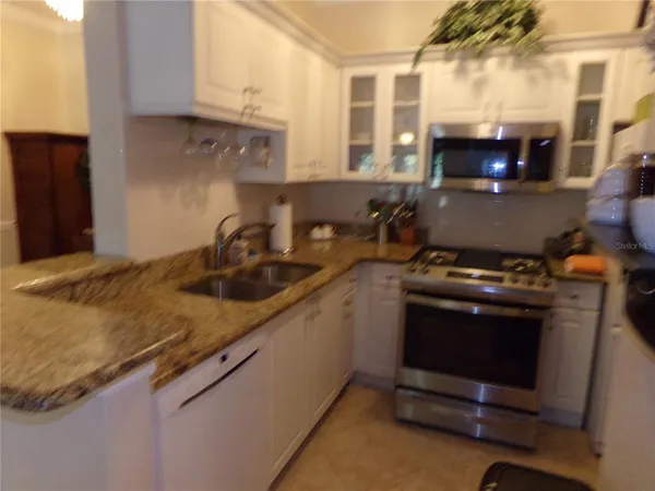 a kitchen with a sink and a stove top oven