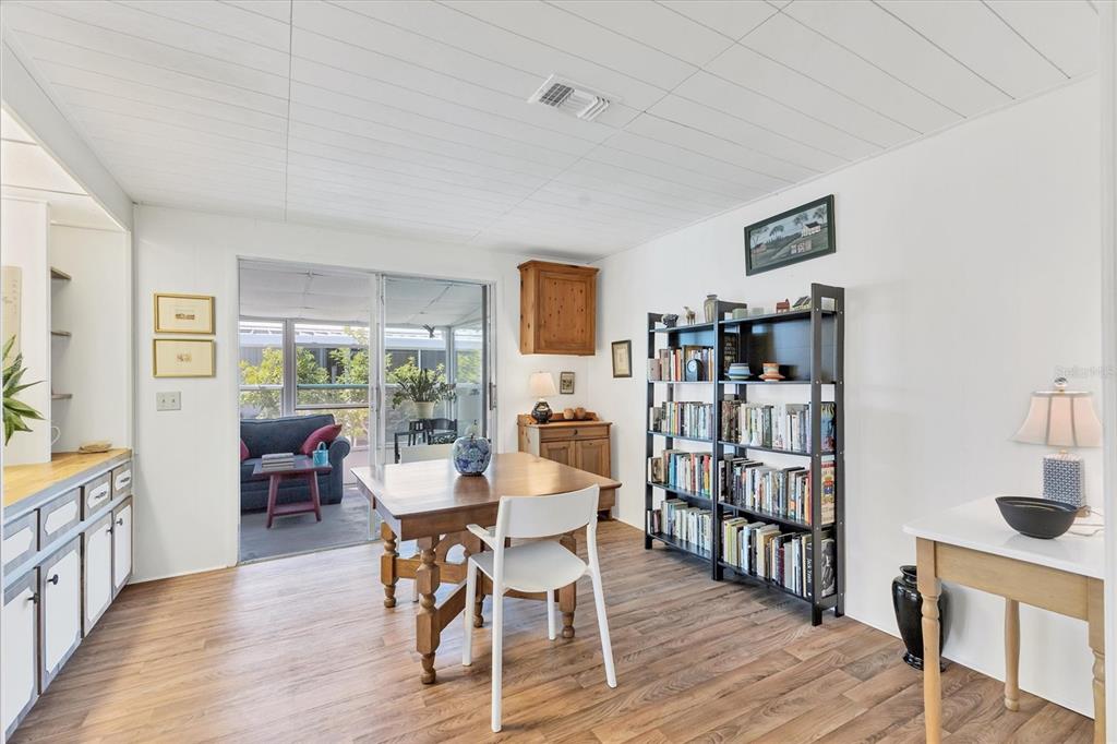 985 Jolanda Circle Venice, FL 34285 - Photo 14 of 49 a dining room with furniture wooden floor and a book shelf